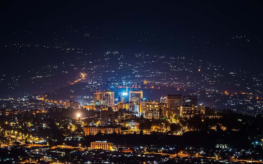 Kigali: Sunset Drinks, Dinner, and Nightlife Tour - A Kigali sunset with a drink in hand